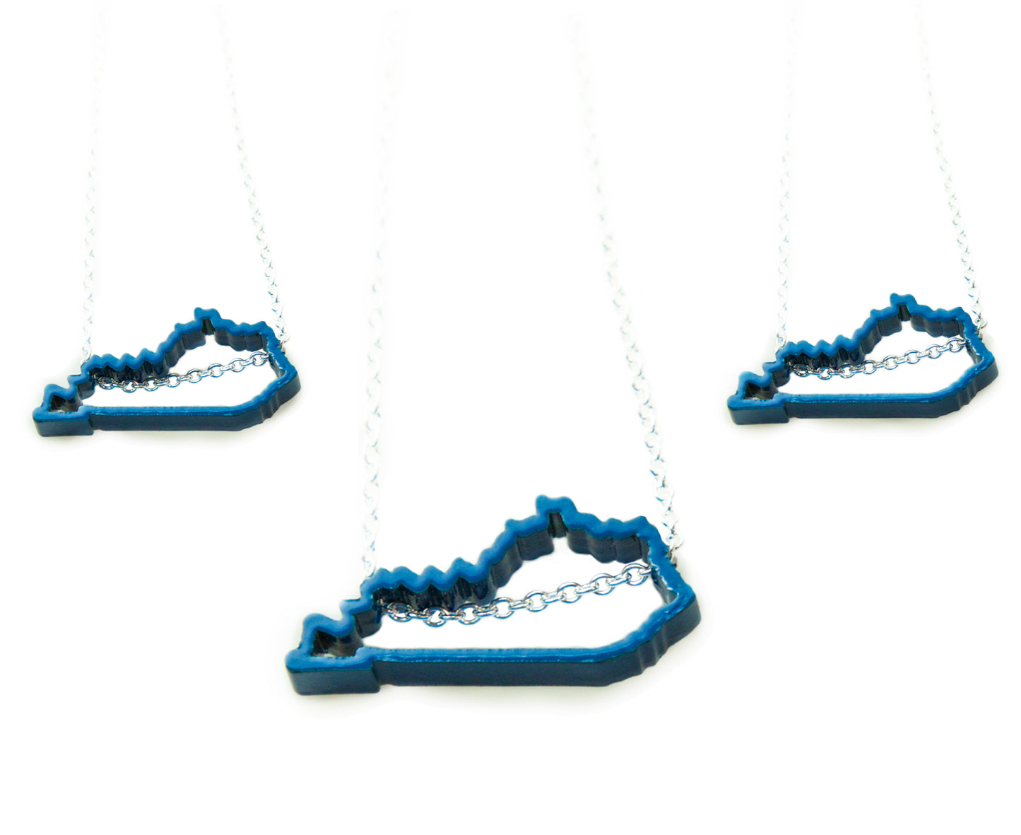 Show your Kentucky state pride with this blue, powder-coated Kentucky outline necklace! Great paired with Meg C's Blue Kentucky State Pin. Size: 1" wide Metal: Blue powder coated brass; 18" Sterling Silver chain Handmade by Meg C
