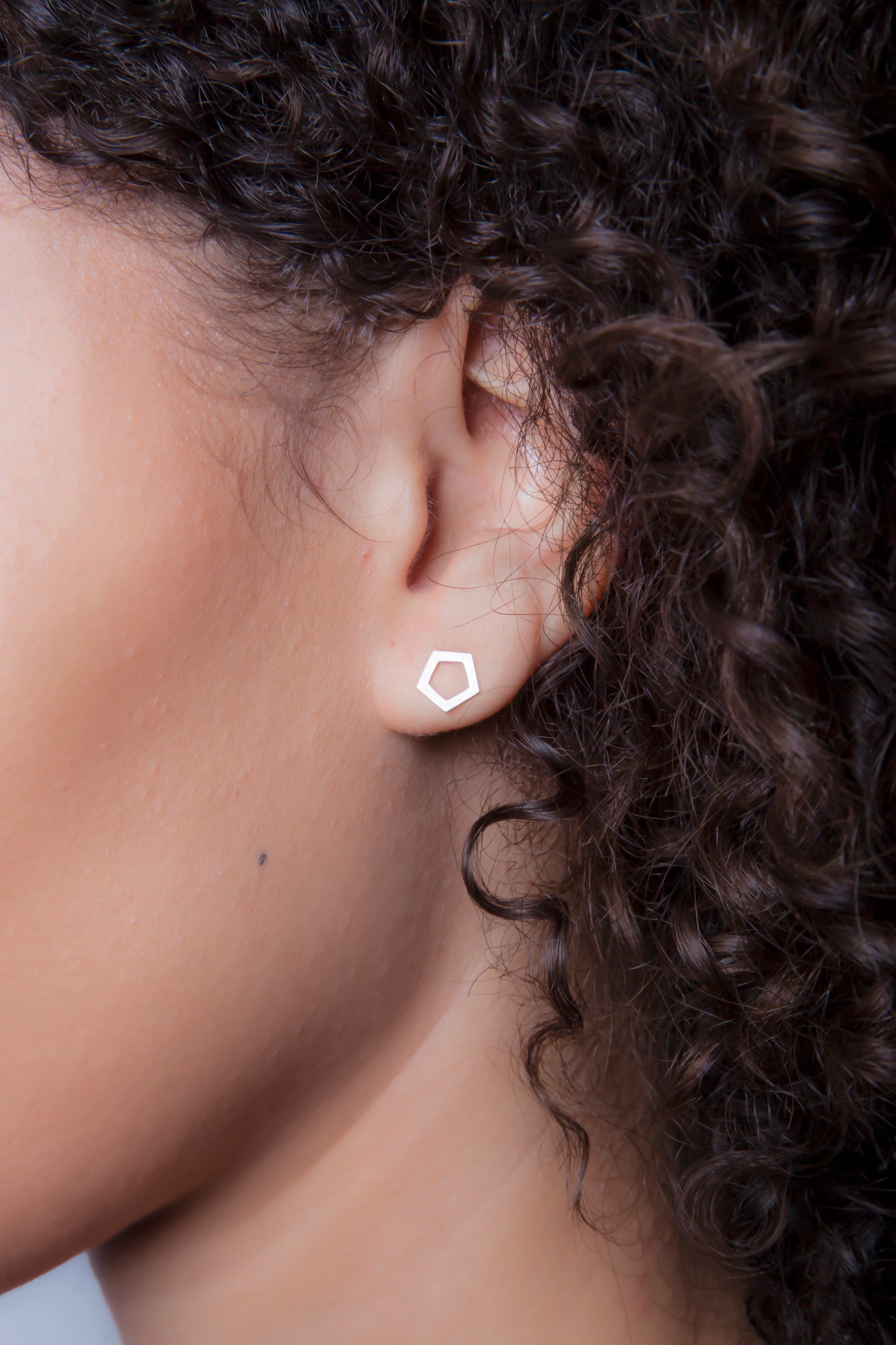 Tiny Pentagon studs in 14k white, yellow, or rose gold. Size: 10mm width Style: Stud Metal: 14k White Gold, Yellow Gold, or Rose Gold Handmade by Meg C