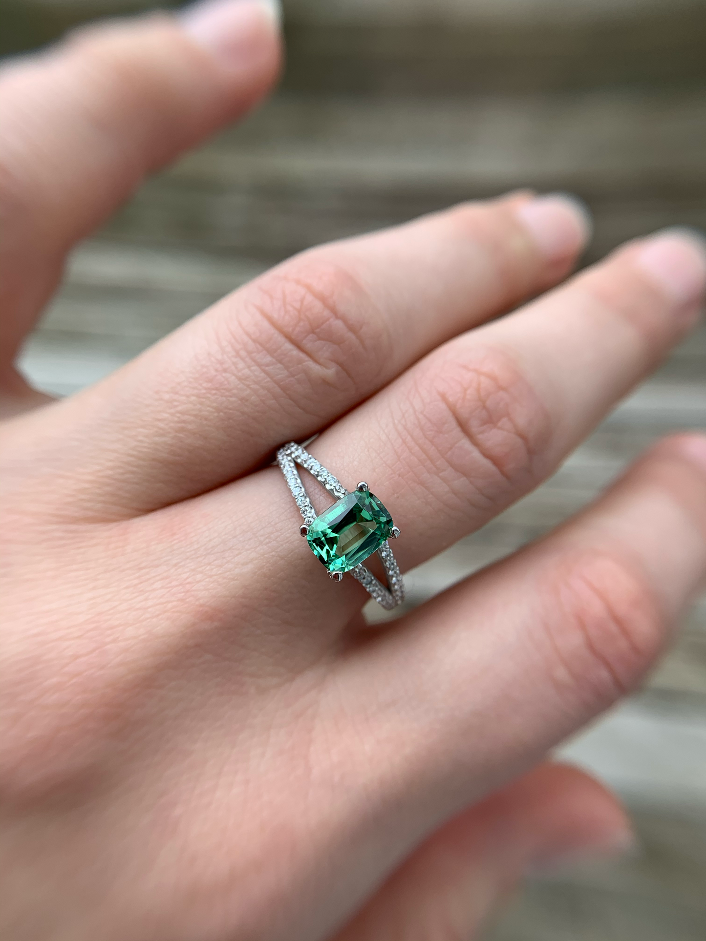 Featuring a glowing, cushion cut, blue-green tourmaline set in a trellis style setting with bead set diamonds flowing from the top of the prongs down the shank. Ring Size: 8 (Can be resized for free, just ask!) Stone: 1.46ct Natural Blue-Green Tourmaline; 0.32ctw Diamonds, G-H, VS Metal: 14k White Gold Handmade by Meg C