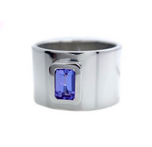 Featuring a bright, beautiful, emerald cut Tanzanite, bezel set in a wide white gold band.  Size: 6 Dimensions: 12mm wide band Stone: .056ct emerald cut Tanzanite Metal: 14k White Gold Handmade by Meg C
