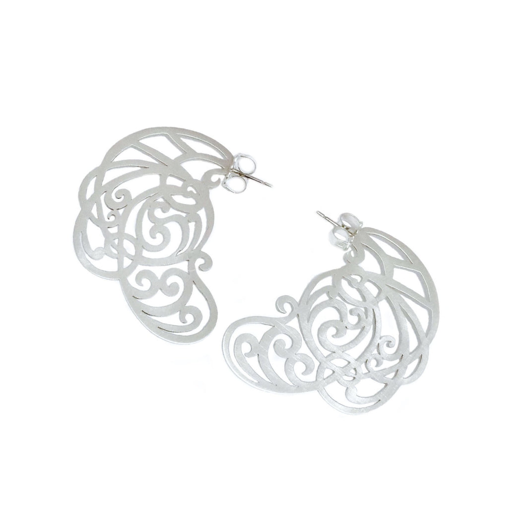 Intricate, hand-cut lace earrings in sterling silver, with 14k white gold posts.   Size: 45mm long Style: Drop Metal: 14k White Gold Post; Sterling Silver Handmade by Meg C