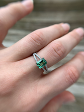 Featuring a glowing, cushion cut, blue-green tourmaline set in a trellis style setting with bead set diamonds flowing from the top of the prongs down the shank.  Ring Size: 8 (Can be resized for free, just ask!) Stone: 1.46ct Natural Blue-Green Tourmaline; 0.32ctw Diamonds, G-H, VS Metal: 14k White Gold Handmade by Meg C