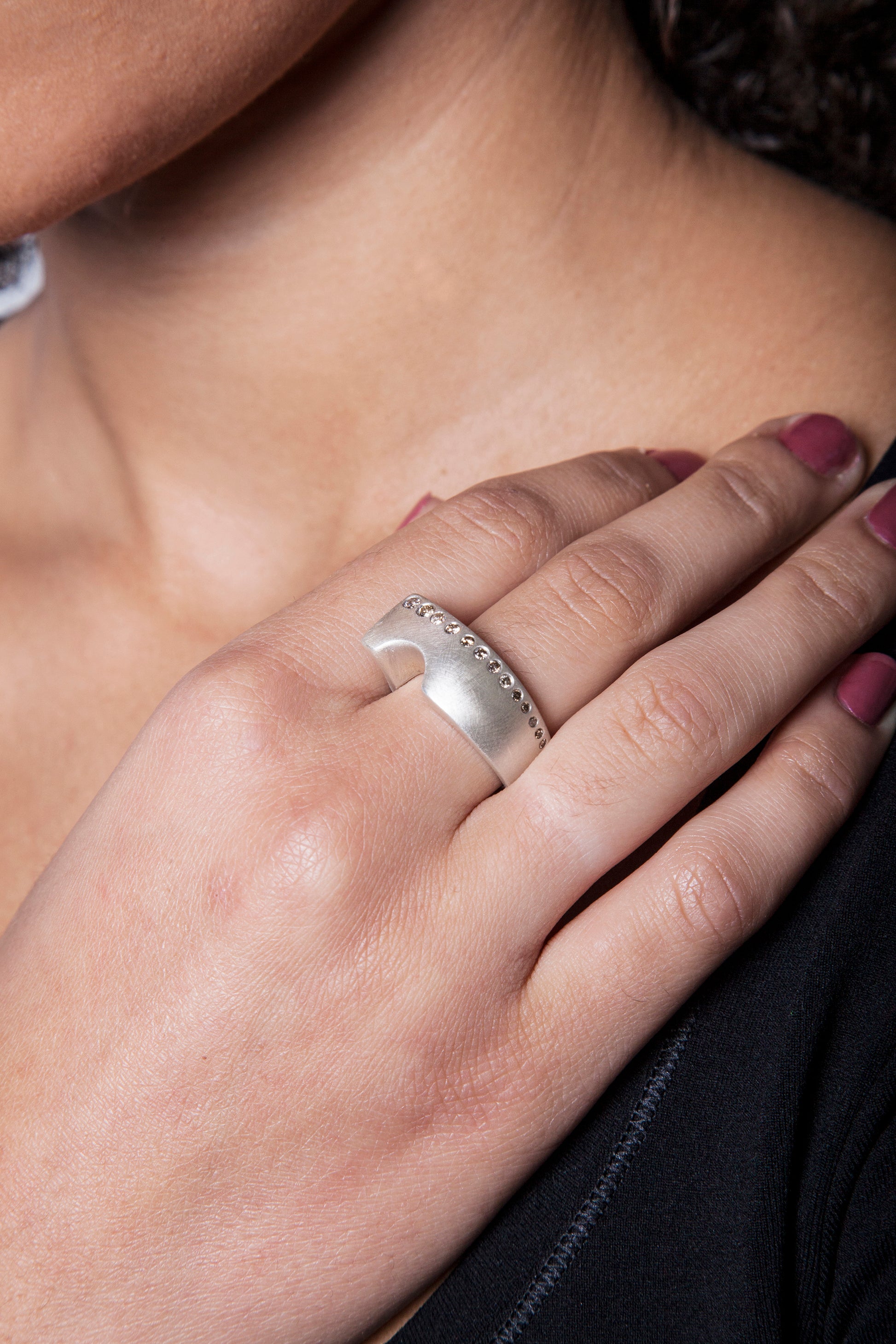 Make waves with this one-of-a-kind ocean inspired ring! Accented with a row of flush set champagne diamonds.  Size: 9 (can be resized); 11mm at top tapering to 7mm at base Stone: Champagne Diamonds Metal: Sterling Silver Handmade by Meg C